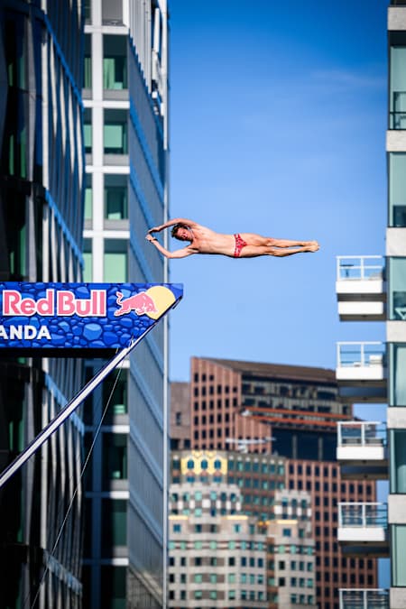 Gary Hunt of France performs a breathtaking dive from the 27 metre platform atop the Institute of Contemporary Art during the final stop of the Red Bull Cliff Diving World Series in Boston, 2025