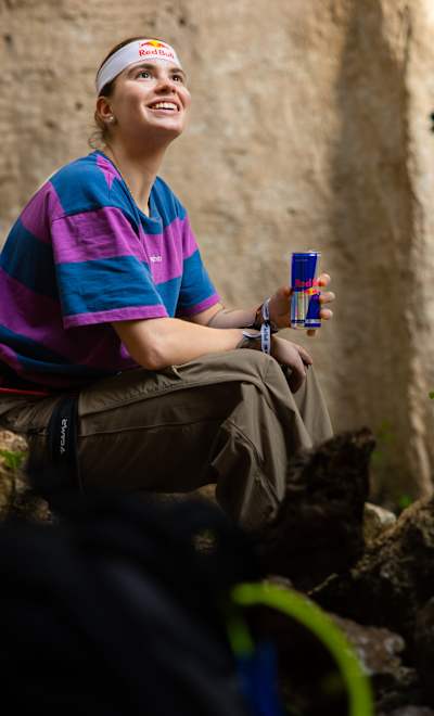 On April 4, 2025, Beatrice Colli enjoys a Red Bull during the adrenaline-fuelled Red Bull Ivy event amidst the rugged cliffs of Finale Ligure, Italy.