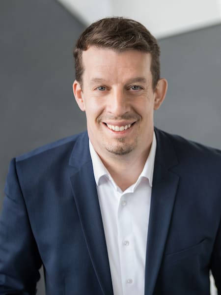 Portrait of Deniz Keskin, Director of Brand Management at Porsche, who is a guest on the Red Bull Basement Sessions podcast.