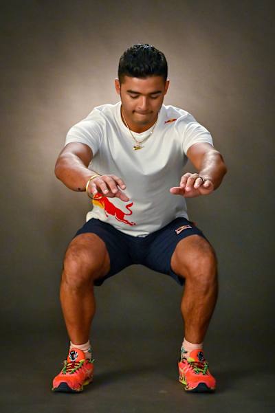 Indian cricket all-rounder Riyan Parag performs warm-up exercises to be done before a cricket match