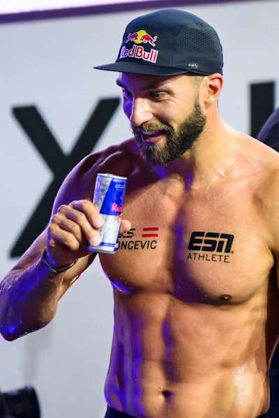 Alexander Rončević celebrates HYROX title with a Red Bull.