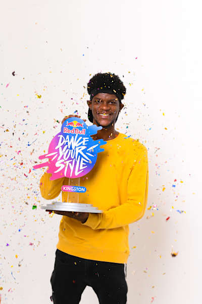 Winner portrait of Flexx Cautiion holding the Red Bull Dance Your Style Kingston trophy.