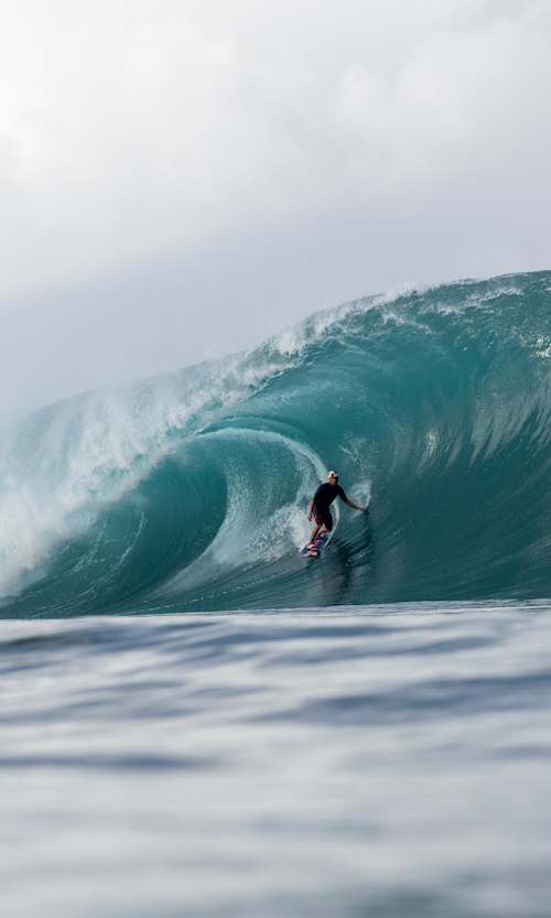 Kai Lenny takes on a massive wave at Teahupo'o in Tahiti, surfing switch foot during an epic Red Bull session on August 5, 2025.