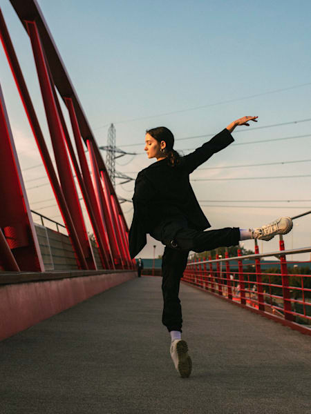 Francesca Velicu dances on a bridge.