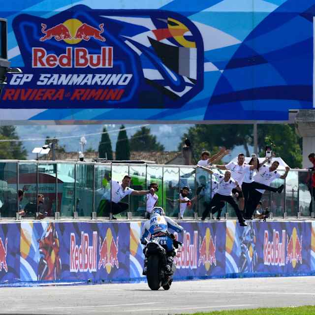 Álex Márquez rides down the pit lane as his team celebrates victory during the San Marino MotoGP World Championship at Misano, Italy, on September 14, 2025
