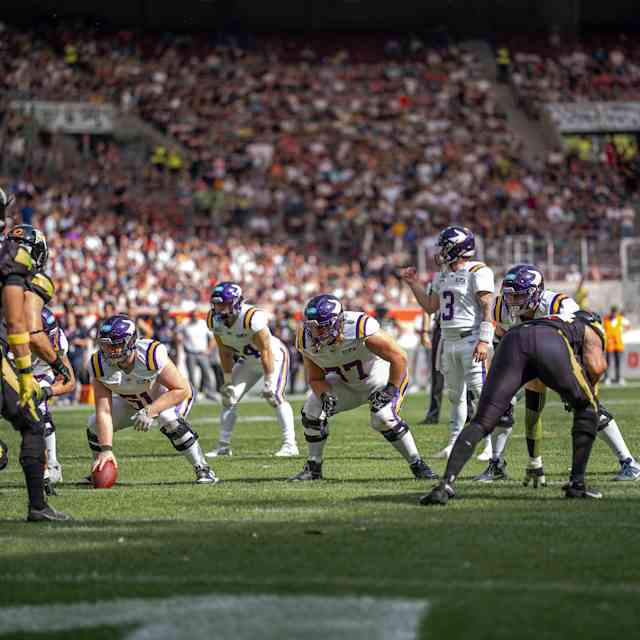 Vienna Vikings and Stuttgart Surge players, in the American Football League Europe, crouched face-to-face before the snap