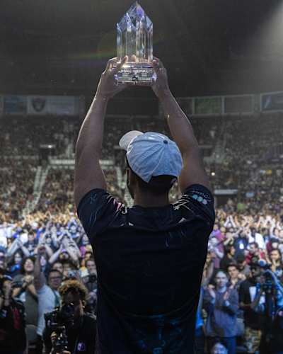 Arslan Ash lifting the champion's trophy at EVO 2023