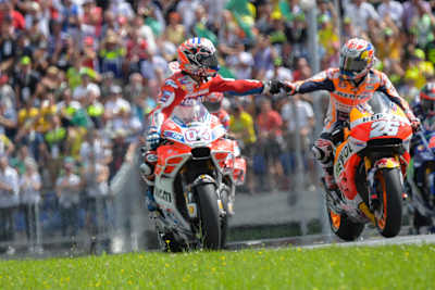 MotoGP riders Andrea Dovizioso and Dani Pedrosa immediately immediately after the finish of the Austrian MotoGP race.