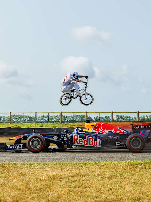 BMX rider Kriss Kyle leaps over Red Bull F1 car 