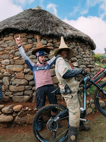 Mountain bikers Matt Jones and Rob Warner have fun with locals in Lesothoduring filming for the Red Bull TV show Rob Warner's Wild Rides.