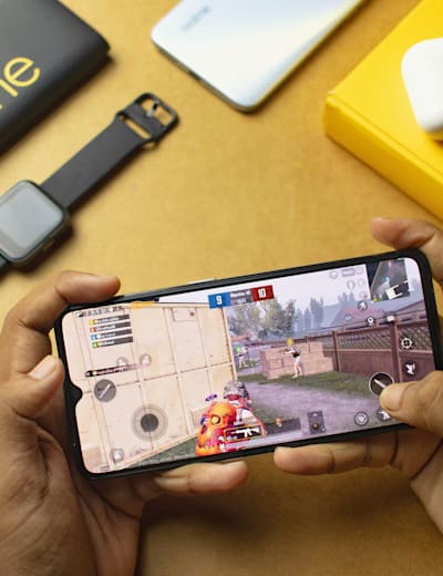 A gamer plays PUBG Mobile on a realme phone.