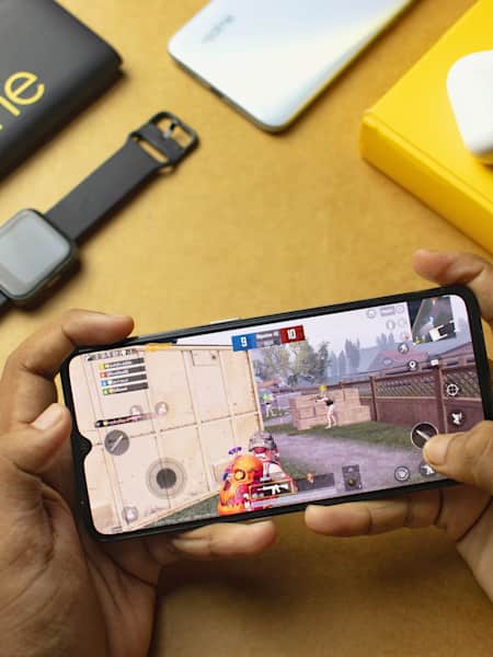 A gamer plays PUBG Mobile on a realme phone.