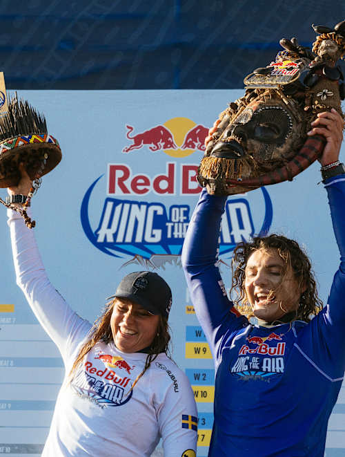Nathalie Lambrecht and Lorenzo Casati celebrate on the podium during Day 3 of Red Bull King of the Air 2025 in Cape Town, South Africa, proudly lifting their unique event trophies