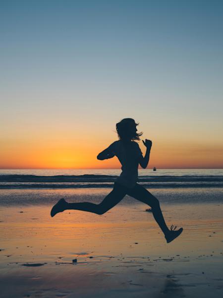 Running over beach at sunset.