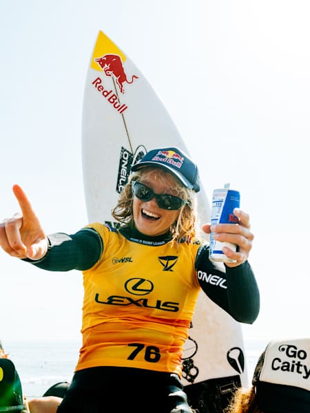 Caitlin Simmers is chaired up the beach after winning the WSL Finals at Lower Trestles.