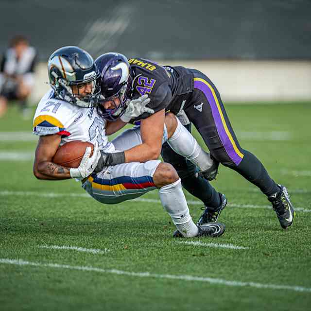 A Vienna Vikings player tackles a Berlin Thunder player for the football at the May 23, 2026 American Football League Europe game in Vienna, Austria