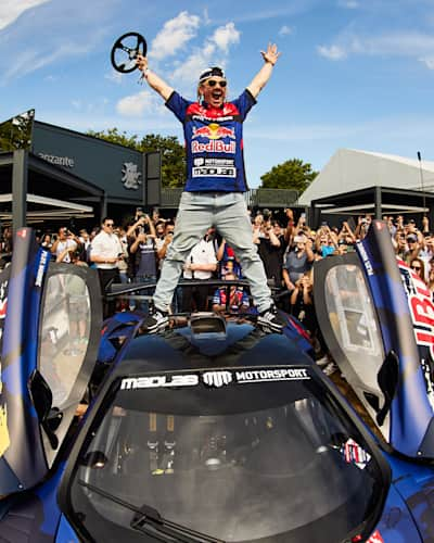 Mike Whiddett celebrates atop his MADMAC McLaren P1 drifting car at the 2024 Goodwood Festival of Speed.