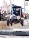 A participant dressed as Superman races a wacky soapbox vehicle at the Red Bull Soapbox Race event in Amman, Jordan in 2023