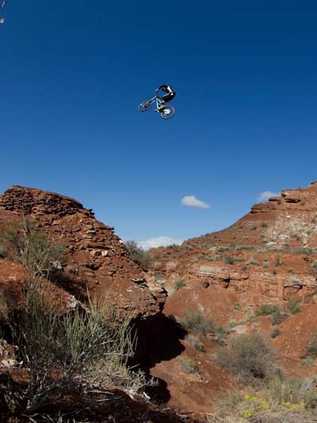 Mountain biker Tom van Steenbergen goes big over the canyon gap at Red Bull Rampage 2013.