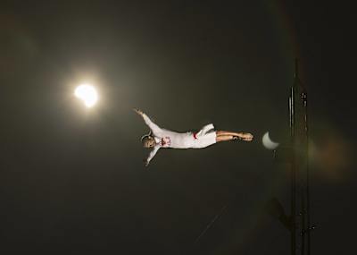 An image of cliff diver Orlando Duque diving at night. 