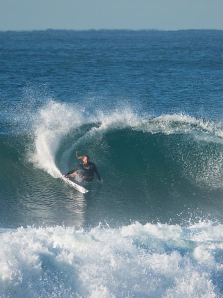 Professional surfer from South Africa, Ricky Basnett, does a power carve at his local break, Cave Rock, located in Durban.