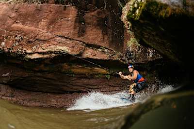 With the use of a high powered winch, Mike Dowdy wakeboards in natural natural caves found along the shores of Lake Superior in northern Wisconsin, USA on July 11, 2017.