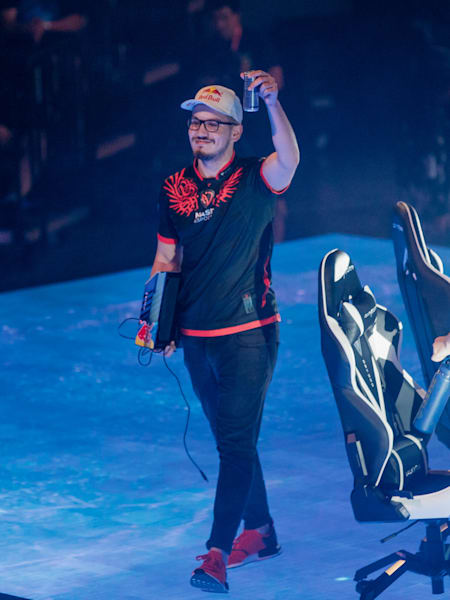 A photo of Adel raising up a can of Red Bull.