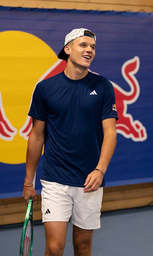 Tennis star Jakub Menšík is pictured in action on a tennis court in Prague, Czech Republic. 