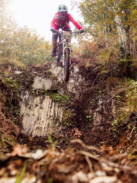 Un rider avance dans la boue d'une piste mouillée au Red Bull Foxhunt 2018 à Rostrevor en Irlande.