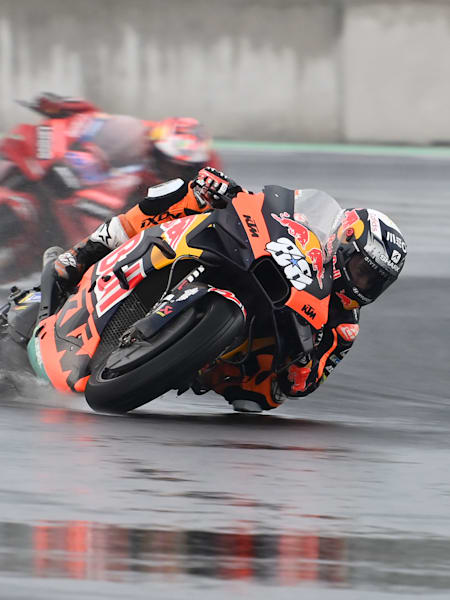 KTM rider Miguel Oliveira leads the Ducati of Jack Miller in the rain at the 2022 Indonesian MotoGP™.