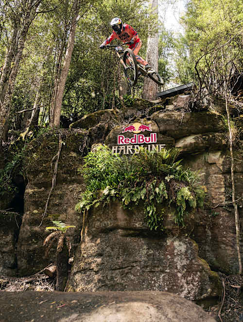 Jackson Goldstone tackles a daring jump through the forest during practice at Red Bull Hardline 2026 in Maydena Bike Park, Australia, capturing the thrill of downhill mountain biking