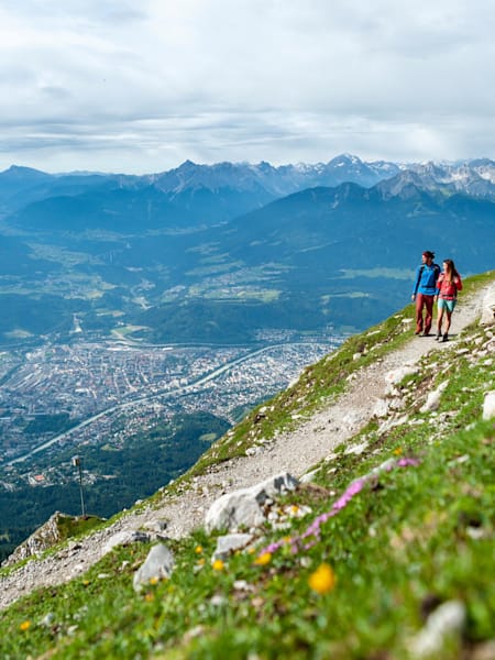 A couple walk in the mountains above Innsbruck.