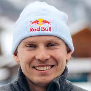 In 2023, Henrik Kristoffersen smiles wearing a Red Bull beanie at Reiteralm, Austria.