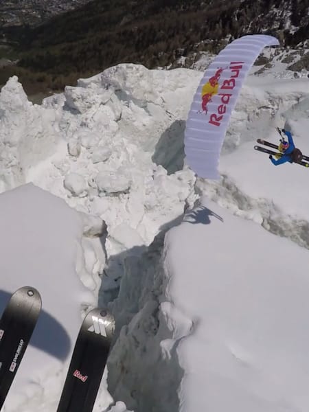 Speedrider Valentin Delluc flies above the Bossons Glacier with his paraglider and skis