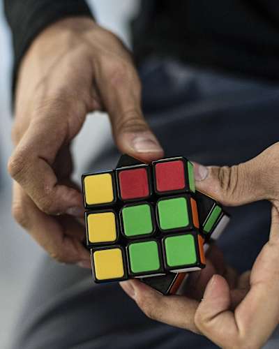 A player works on solving a Rubik's Cube.