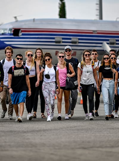 The cliff divers walk from the Flying Bulls Douglas DC-6 after flying to Mostar for the second stop of the Red Bull Cliff Diving World Series, in Mostar, Bosnia and Herzegovina on August 24, 2021.