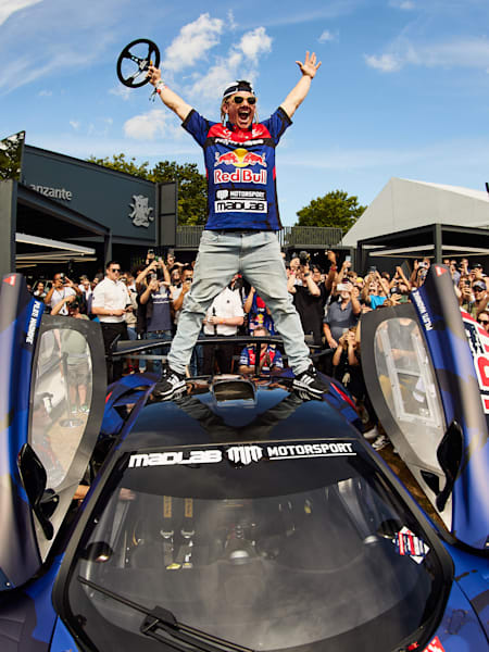 Mike Whiddett celebrates atop his MADMAC McLaren P1 drifting car at the 2024 Goodwood Festival of Speed.