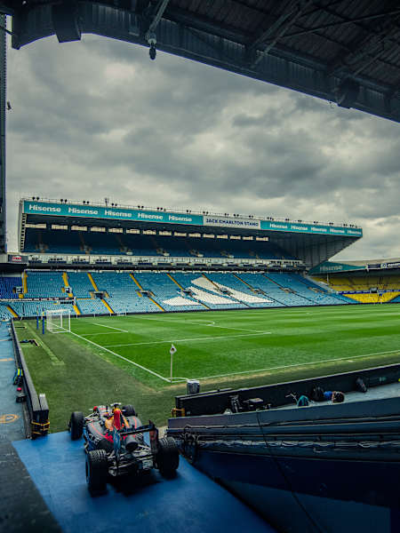 An Oracle Red Bull Racing Formula One car sits pitchside at Elland Road Stadium, Leeds, during the 2025 meeting with Leeds United Football Club and Arvid Lindblad