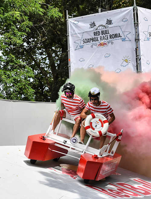 On June 24, 2018, adventurers race down the Red Bull Soapbox Race Roma track in Rome, Italy, surrounded by colourful smoke and high-energy excitement