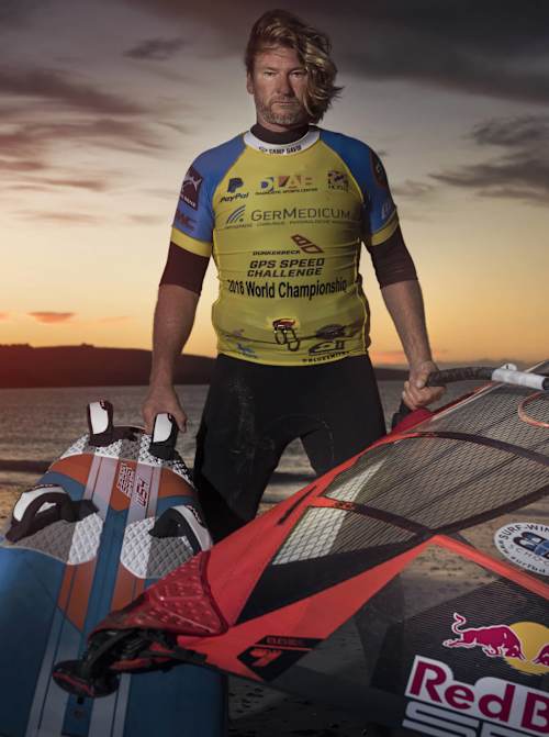 Björn Dunkerbeck poses with Red Bull-branded windsurfing equipment during the Dunkerbeck GPS Speed Challenge at sunset in Costa Calma, Fuerteventura, Spain (June 2016).