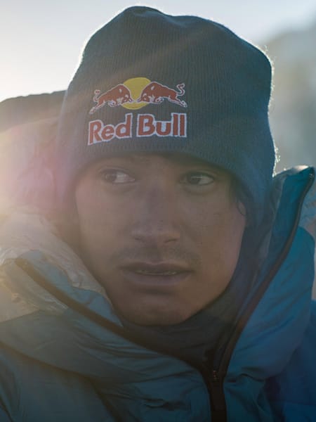 Portrait of Austrian mountaineer David Lama at top of a mountain.
