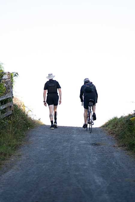 Conor O'Keeffee, on foot, and his father Greg, on bike