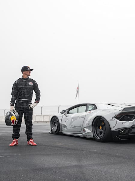 'Mad' Mike Whiddett poses for a portrait on the track next to his custom-built Lamborghini Huracán drift car.