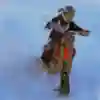 Renner rips through a snow bank on a snow bike