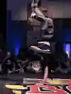 A breaker in action upside down during a Red Bull BC One contest.