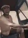 An image of a Tuk Tuk driver in his vehicle.