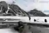 Stefan Glowacz uses his sled as a boat on Baffin