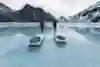 Two men pull sleds across ice