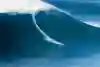 Surfer drops into a big left on opening day at Nazaré Portugal
