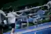 Players compete in a 3-a-side badminton match.